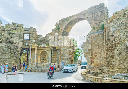 SIDE, TURKEY - MAY 8, 2017: The main city road - Liman Cadessi runs through the Monumental Gate, preserved since the times of Romans, nowadays transpo Stock Photo