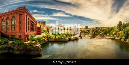 Panoramic cityscape view of Washington Water Power building and the Monroe Street Bridge along the Spokane river, in Spokane, Washington. Stock Photo