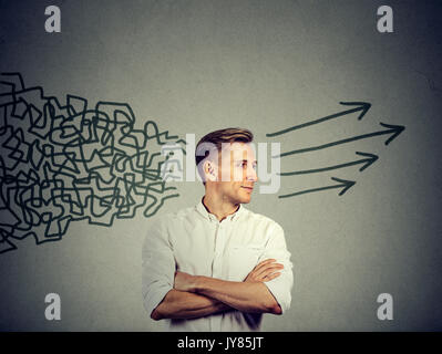 Side profile young man looking at his side getting his thought together isolated on gray wall background Stock Photo