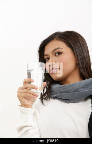 malay woman holding a glass of water Stock Photo