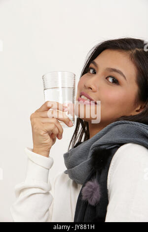 malay woman holding a glass of water Stock Photo