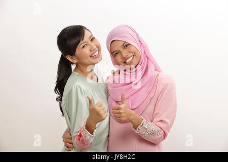 Happy two malay women on the white background Stock Photo