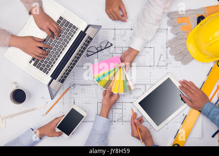 Hands of professional architects discussing and working with blueprints Stock Photo