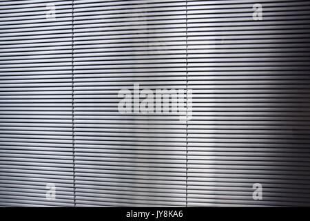 horizontal blinds behind a window for privacy and sun protection Stock Photo
