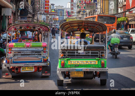 Colorful Tuk Tuk in the traffic of Thanon Yaowarat road, Chinatown District, Bangkok, Thailand Stock Photo