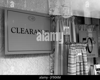 Sale clearance sign in drapery retail shop window Stock Photo