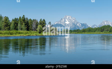 The light blue colours of the Snake river by the oxbow bend with a reflection of the Grand Teton range, Wyoming state, United States of America (USA). Stock Photo