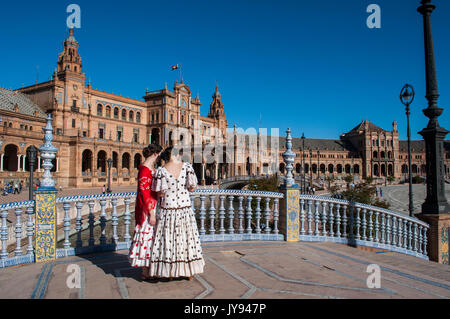 Spain: girls of Seville in typical dresses in Plaza de Espana, the most famous square of the city, ready for the Seville Fair (Feria de abril) Stock Photo