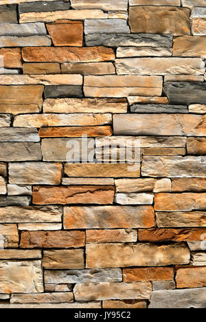 An irregular assortment of stone creating a stone wall background. Stock Photo