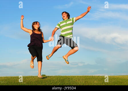 A young couple jump for joy. Stock Photo