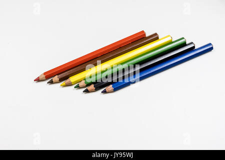 Cute baby pencil crayons on a white table. Isolated background. White background. Stock Photo