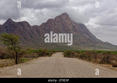 Rain clouds over the Otjipateraberge (Otjipatera Mountains), gravel road D1952, rainy season, Karibib District, Erongo region, Namibia Stock Photo
