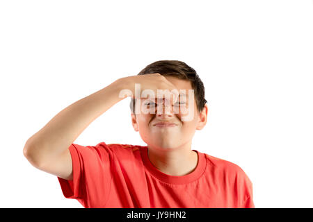 A young teenage boy isolated against white background with a migraine Stock Photo
