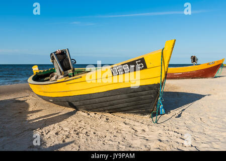 DEBKI, POLAND, AUGUST 15, 2017: Colorful fishing boats on sandy beach in Debki village, Baltic Sea, Poland. Stock Photo
