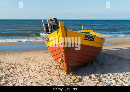 DEBKI, POLAND, AUGUST 15, 2017: Traditional fishing boat on sandy beach in Debki village, Baltic Sea, Poland. Stock Photo