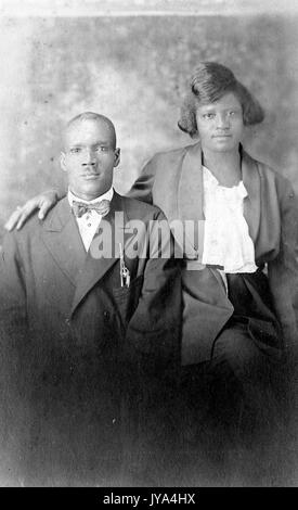 African American couple, a man and woman posing for a studio portrait, the woman with her arm resting on her husbands shoulder, the man wearing a suit and bow tie, Saint Louis, Illinois, 1932. Stock Photo