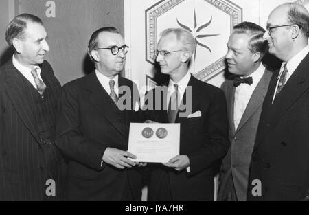 American television host Lynn Poole receiving an award for his work on the television show The Johns Hopkins Science Review, 1955. Stock Photo