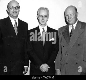 Executive Ben Cohen, American television host Lynn Poole, and Dr Allen B DuMont are standing in order from left to right, they are all wearing business suits and ties, they are smiling for the camera, 1950. Stock Photo