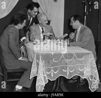 Set of the 'Are You Too Fat?' segment of the Johns Hopkins Science Review, featuring (clockwise from left) Warren Wightman, producer of the Johns Hopkins Science Review; Paul Kane, director of the Johns Hopkins Science Review; American television host Lynn Poole; and Robert Fenwick, associate producer for WAAM Baltimore, September 29, 1952. Stock Photo