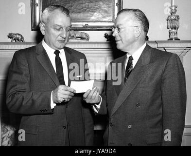Milton Stover Eisenhower (left), president of Johns Hopkins University, being presented a check, 1965. Stock Photo