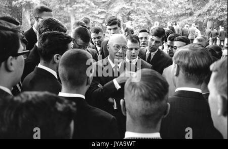 Milton Stover Eisenhower, president of Johns Hopkins University, surrounded by a crowd, 1964. Stock Photo