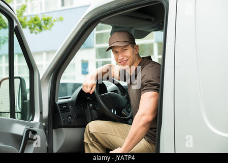 Young Happy Delivery Man Driving Service Delivery Van Stock Photo