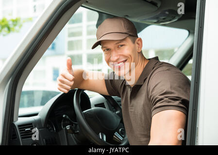 Young Happy Deliverymen Showing Thumb Up Sign In Van Stock Photo