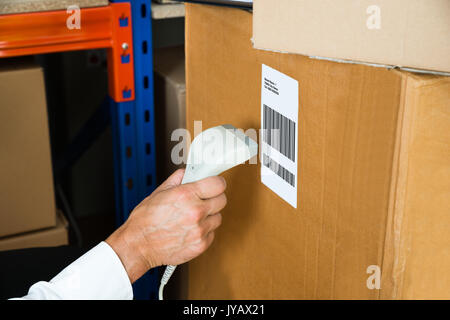 Close-up Person Hands With Barcode Scanner Scanning Label On Box Stock Photo