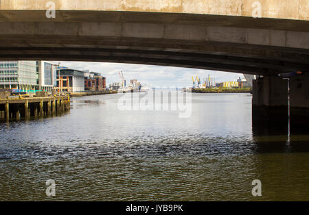 A view down the Belfast lough toward the Irish sea through one of the arches of the Dargan Railway Bridge in Belfast Northern Ireland Stock Photo