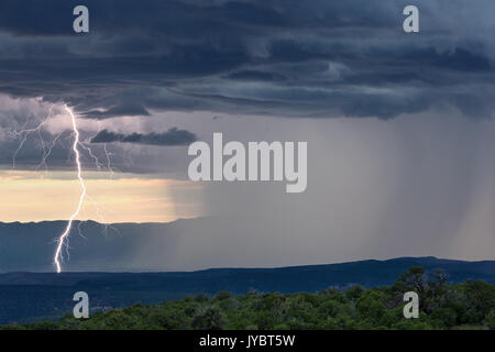 Powerful lightning bolt strike and heavy rain from a monsoon thunderstorm over Sedona, Arizona Stock Photo