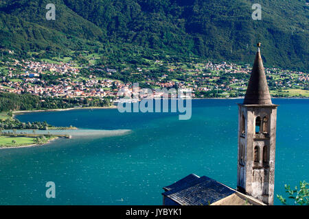 The church tower of Montemezzo overlooking Lake Como. In the background Colico the last town on the eastern shore of Lario. Lombardy. Italy. Europe Stock Photo