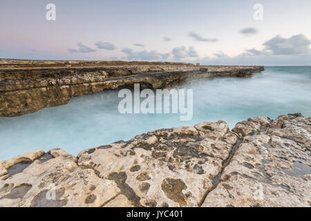 Waves crashing on natural arches carved by the sea at Devil's Bridge Caribbean Antigua and Barbuda Leeward Islands West Indies Stock Photo