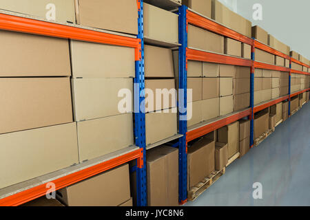 Cardboard Boxes On Shelves In Distribution Warehouse Stock Photo