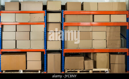 Cardboard Boxes On Shelves In Distribution Warehouse Stock Photo
