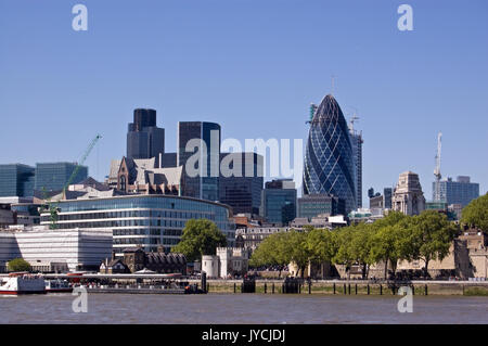 View across the River Thames looking towards the City of London with famour skyscrapers including Tower 42 and The Gherkin. The historic walls of the  Stock Photo