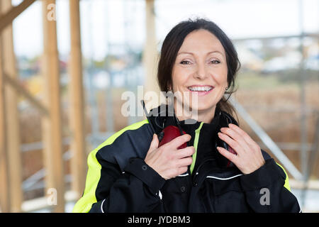 Confident Female Carpenter With Ear Protectors At Construction S Stock Photo