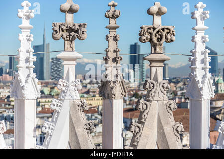 The white marble spiers of the Duomo frame the skyscrapers of Milan Lombardy Italy Europe Stock Photo