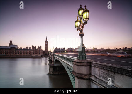 Old street lamp frames Westminster Bridge with Big Ben and Westminster Palace in the background London United Kingdom Stock Photo