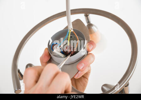 Close-up Of A Person's Hand Repairing Light Stock Photo