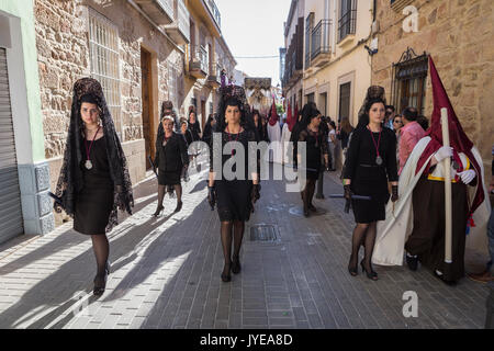 Women dressed in traditional costume called Mantilla during Easter procession in Andalusia, Spain Stock Photo