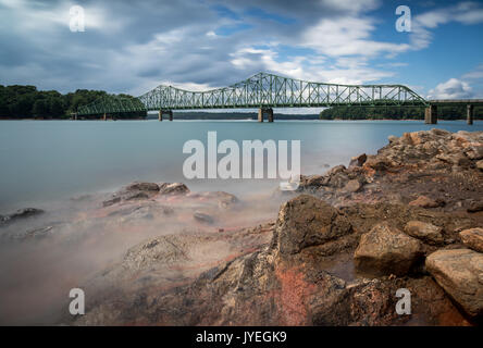 Browns Bridge was built in 1955 over the Chattahoochee River on Lake Lanier.  It replace a low water bridge that was covered by the lake.  That Chattahoochee River is over 400 miles long.  The source is located in Union County, Georgia inside the Chattahoochee National Forest.  The river flows generally southwest and provides much of the water for Lake Sydney Lanier.  After flowing through Atlanta, Georgia, the river meanders more southwest and forms part of the border between Alabama and Georgia.  The river is known by many locals as 'The Hooch'.  Lake Lanier (Lake Sydney Lanier) is a 38,000  Stock Photo