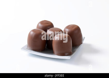 Marshmallows coated in milk chocolate Stock Photo