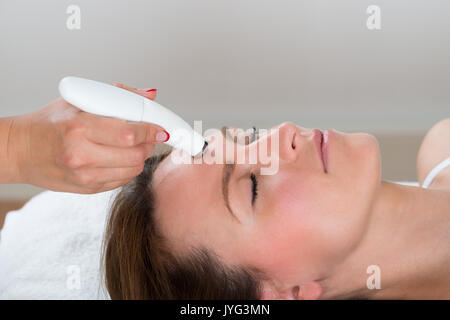 Young Woman Receiving Microdermabrasion Therapy In Beauty Clinic Stock Photo