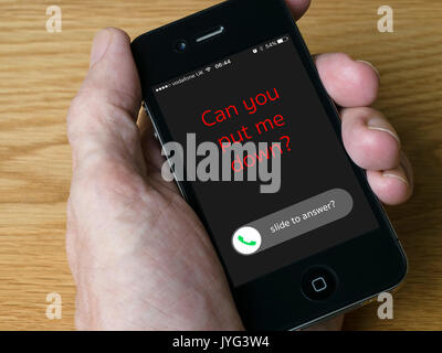 Handheld iPhone mobile phone showing message 'Can you put me down?' addiction to your mobile concept image. Stock Photo