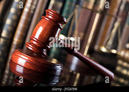 Gavel of the jugde and scale of justice in the court library. Stock Photo