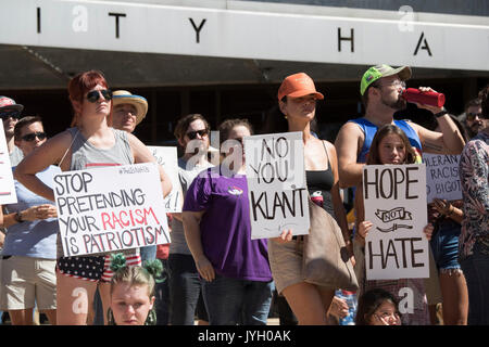 Activists and protesters converge on City Hall for a hot two-hour rally against racism and President Donald Trump's apparent insensitive comments about recent Charlottesville violence that left one dead. About 1,000 gathered in the August Texas heat. Stock Photo