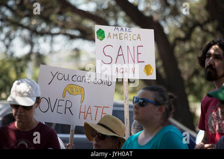 Activists and protesters converge on City Hall for a hot two-hour rally against racism and President Donald Trump's apparent insensitive comments about recent Charlottesville violence that left one dead. About 1,000 gathered in the August Texas heat. Stock Photo