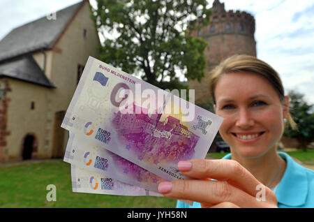 Castle Director Susanne Tiesler showing freshly printed 0 euro bills with the design of Castle Mildenstein in the Castle's courtyard in Leisnig, Germany, 17 August 2017. The souvenir money is printed on real euro paper and counts with all current security measures used on real money. Numerous collectors have expressed interest in the bills, which are limited to 10,000 exemplars and sell for 2 euros. Mildenstein Castle is the third location in Saxony's Castle Region, after Moritzburg Castle and Kriebstein Castle, offering these souvenirs. Photo: Hendrik Schmidt/dpa-Zentralbild/dpa Stock Photo