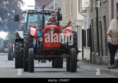 Kington, , UK. 20th Aug, 2017. The Herefordshire market town of Kington came to a standstill while a parade of vintage vehicles made their way to the Kington Vintage Club's 25th Annual Show. Mike George on his vintage Nuffield tractor waves to spectators in Duke Street, Kington. Credit: Andrew Compton/Alamy Live News Stock Photo