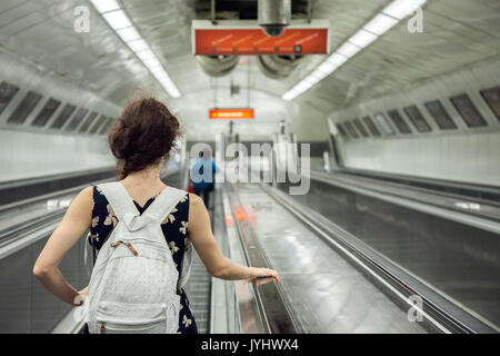 BUDAPEST, HUNGARY - AUGUST 12, 2017: People going down a metro station of Budapest on an escalator  Picture of a family taking an escalator down in a  Stock Photo